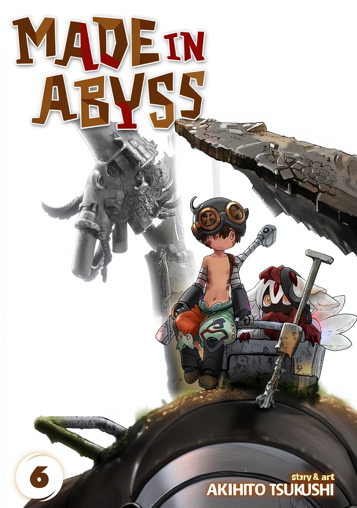 Installing Made in Abyss Manga English Graphic Novel Teen Fantasy on a wooden desk